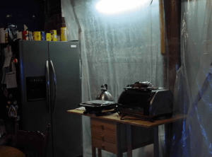 My make shift kitchen including our fridge, panini press, toaster oven and a hot plate.